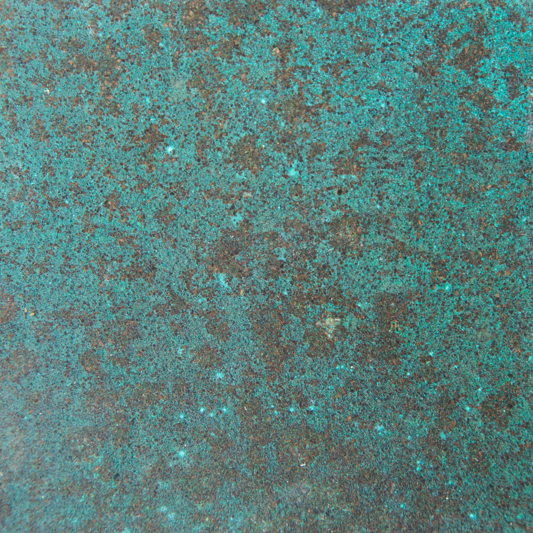 A close-up of KAVA. An interior surface made by pressing coffee waste into a substrate. In this image, it also includes oxidised copper.