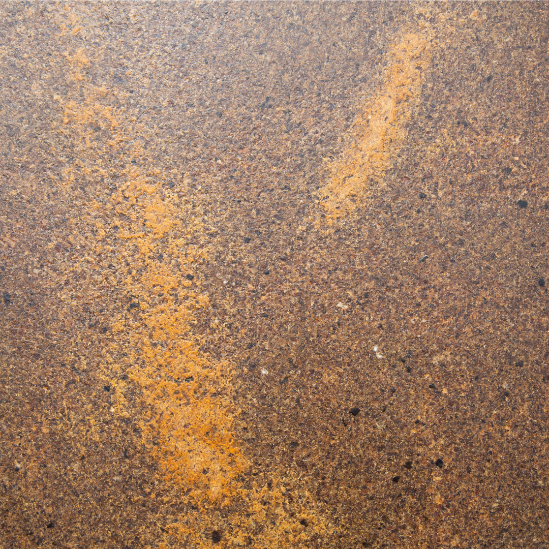 A close-up of KAVA. An interior surface made by pressing coffee waste into a substrate. In this image, it also includes turmeric.